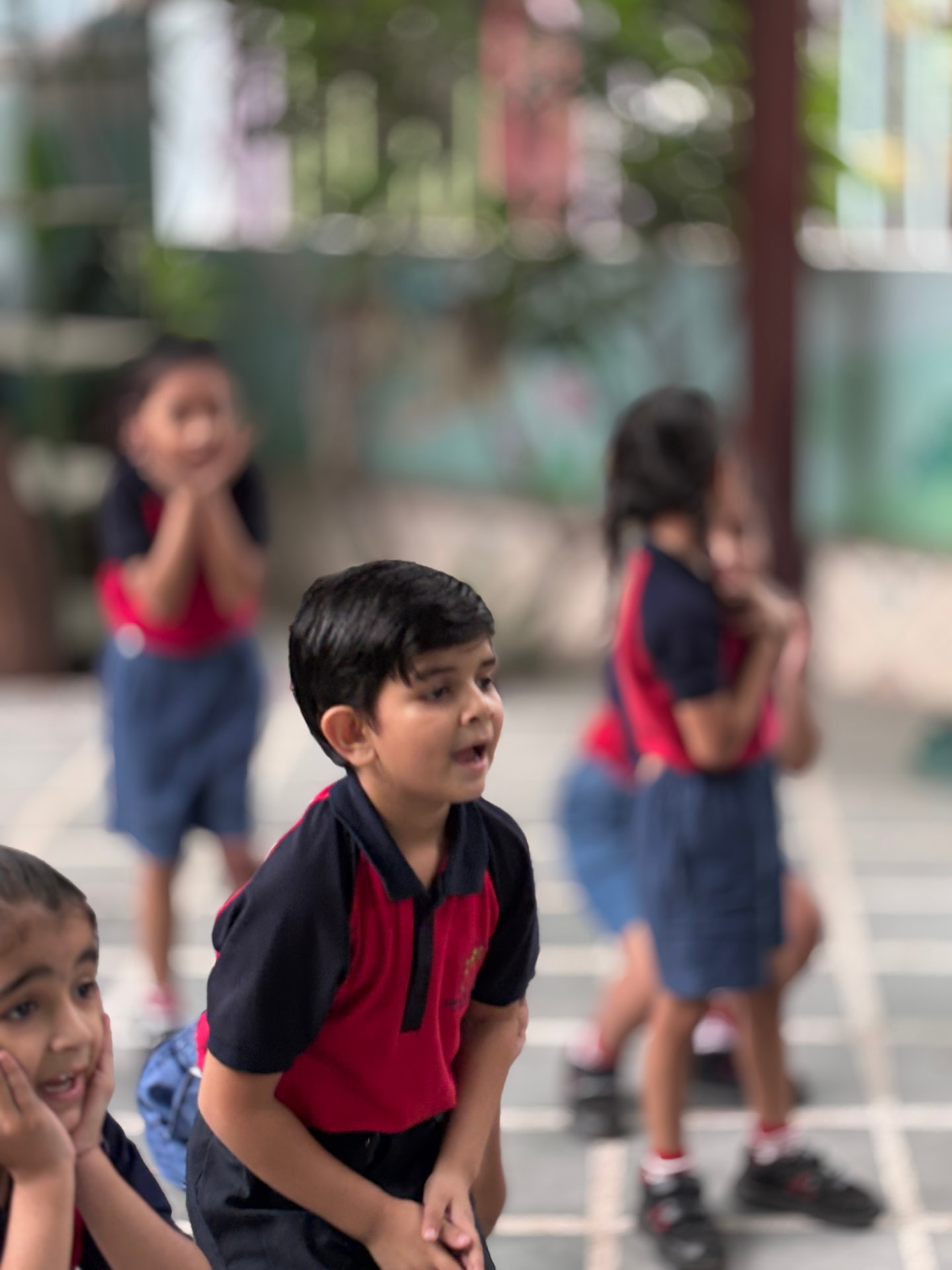 Children clapping along to a rhyme during class time