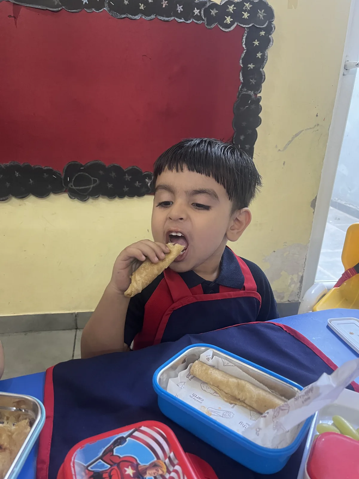 Children sitting together for snack time as part of the daily routine