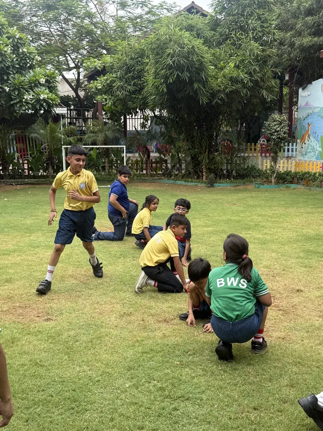 Toddlers exploring outdoors on the school grounds