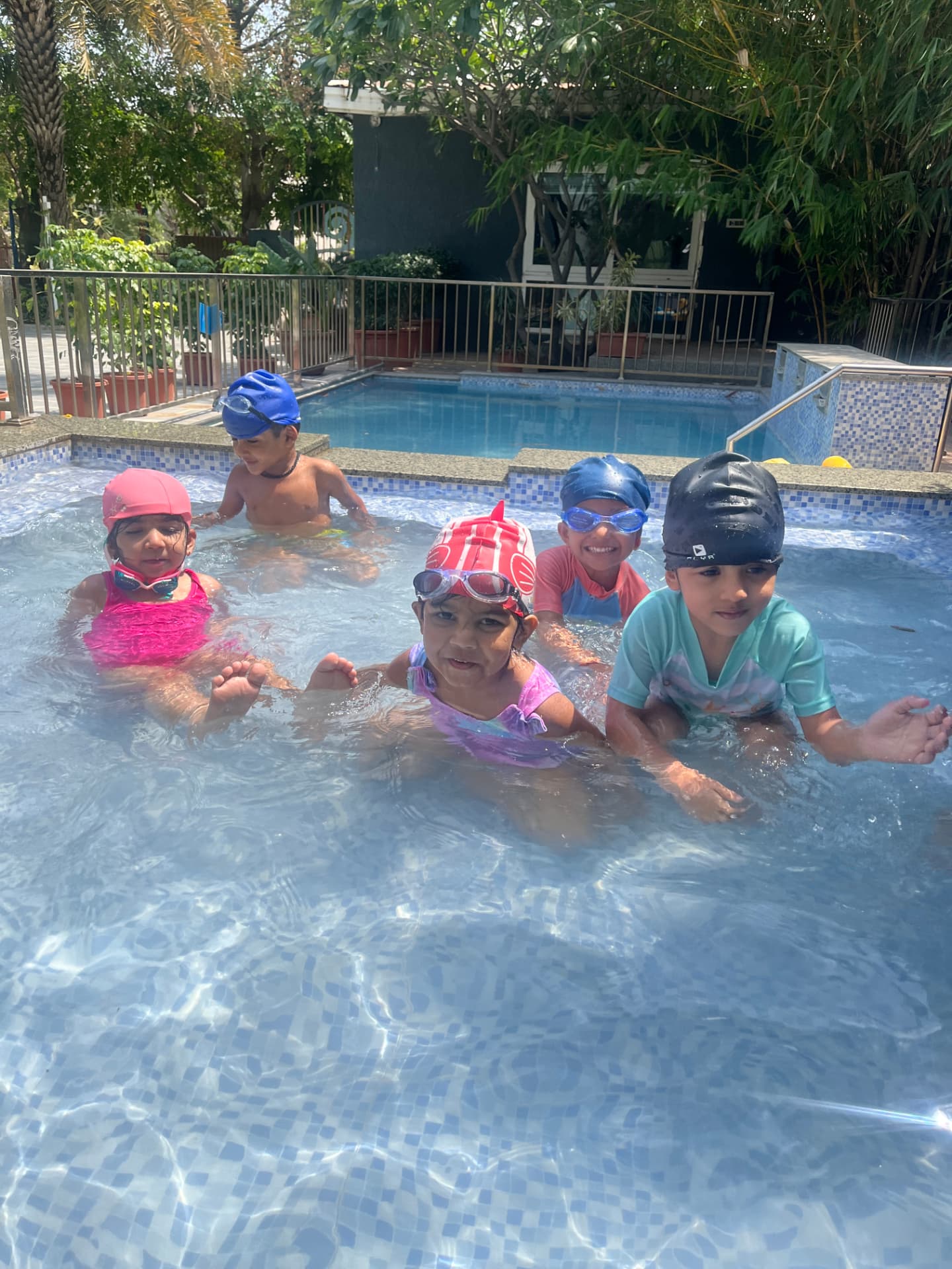 Children enjoying supervised swimming at school