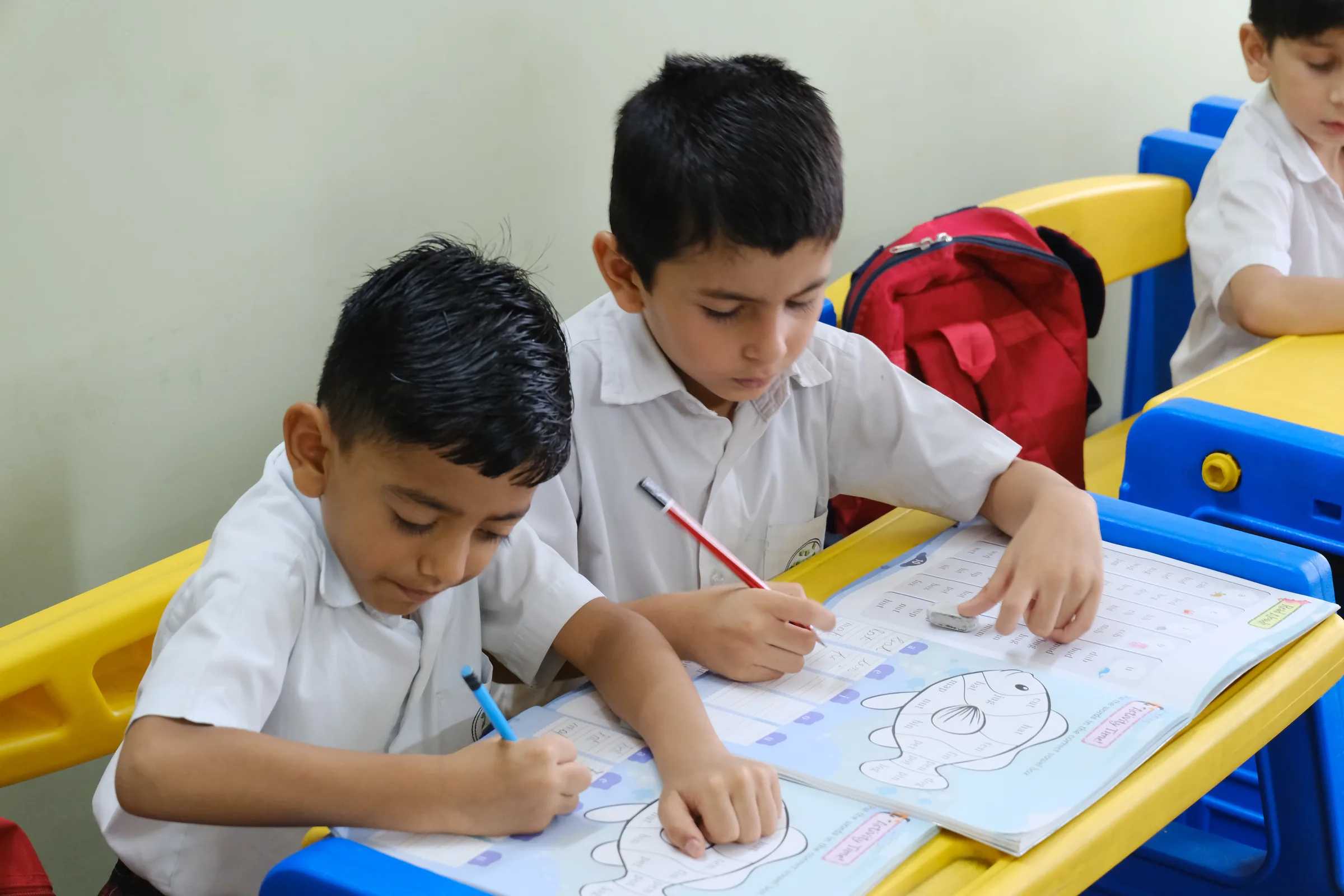 Two Buniyaad students concentrating on a drawing activity