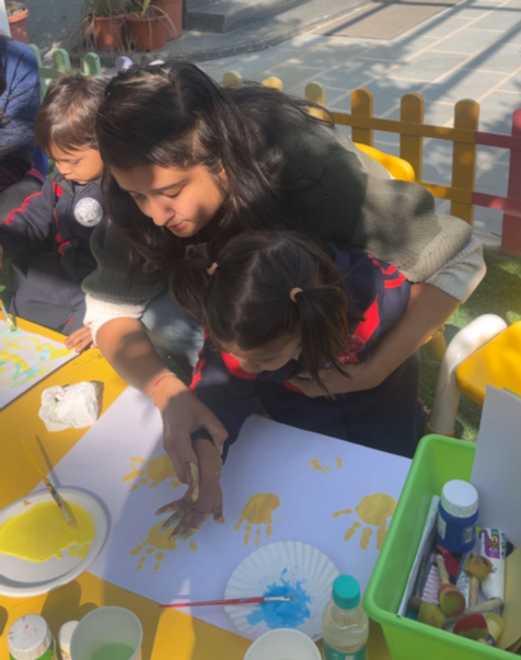 Toddler playing with a teacher outdoors