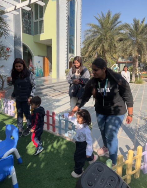 Mothers walking with their toddlers on the school lawn