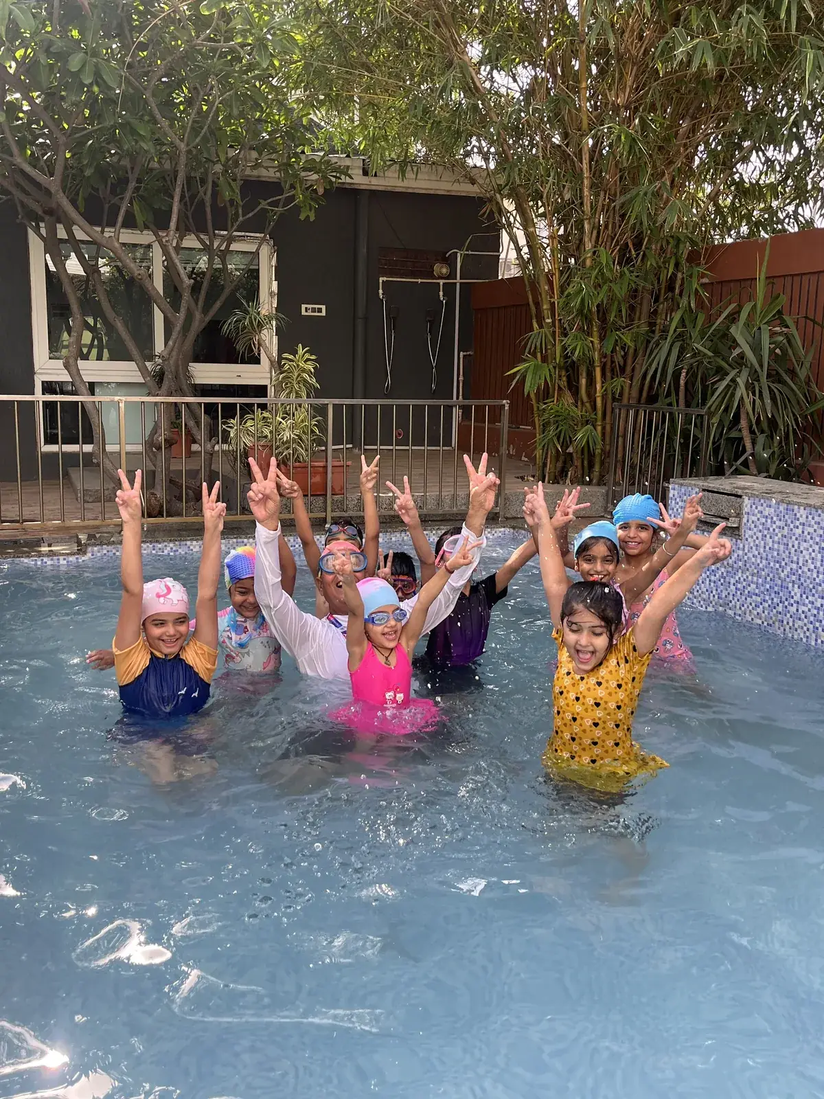 Children having fun in the school swimming pool