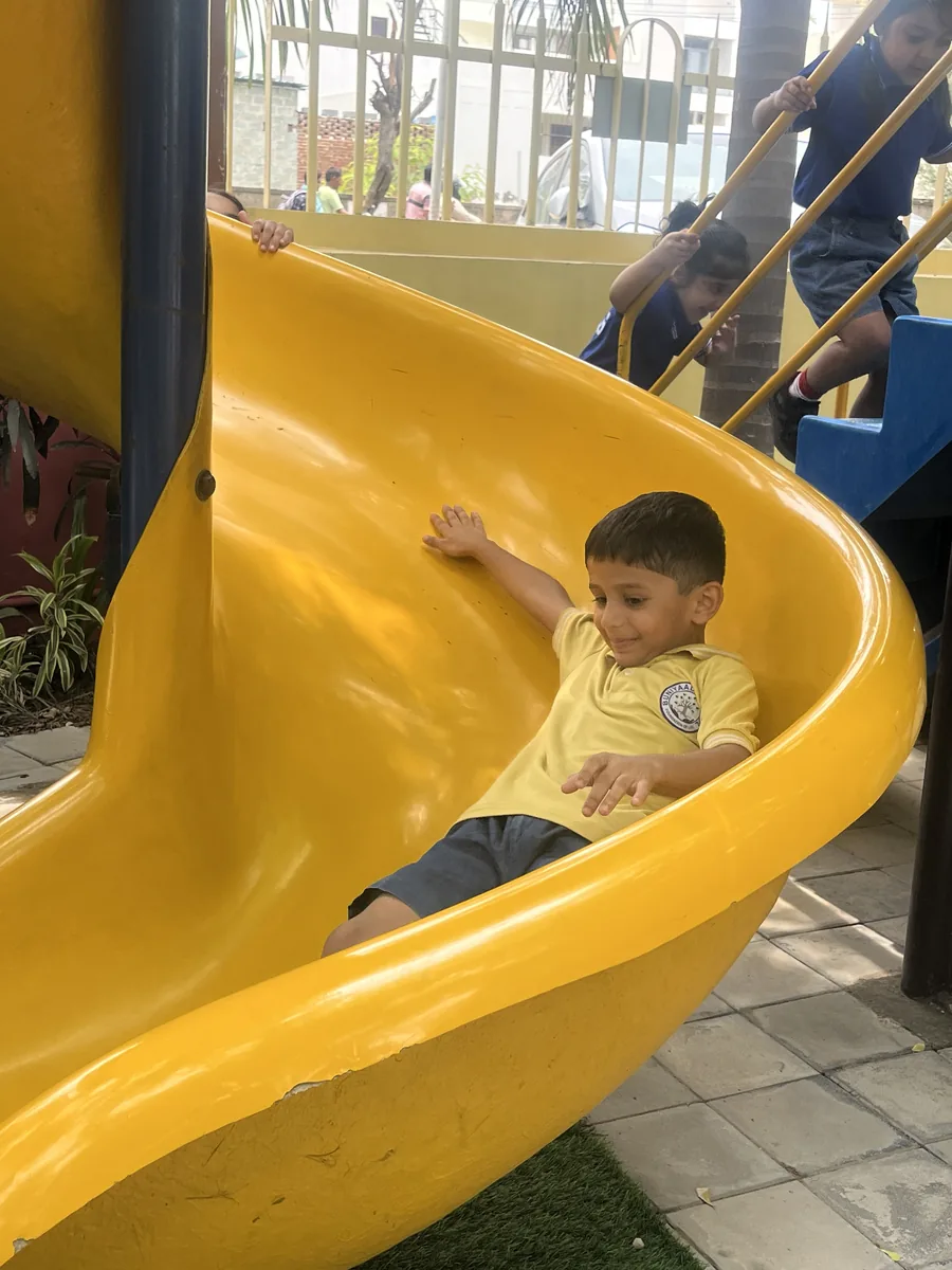 A child sliding down the playground slide
