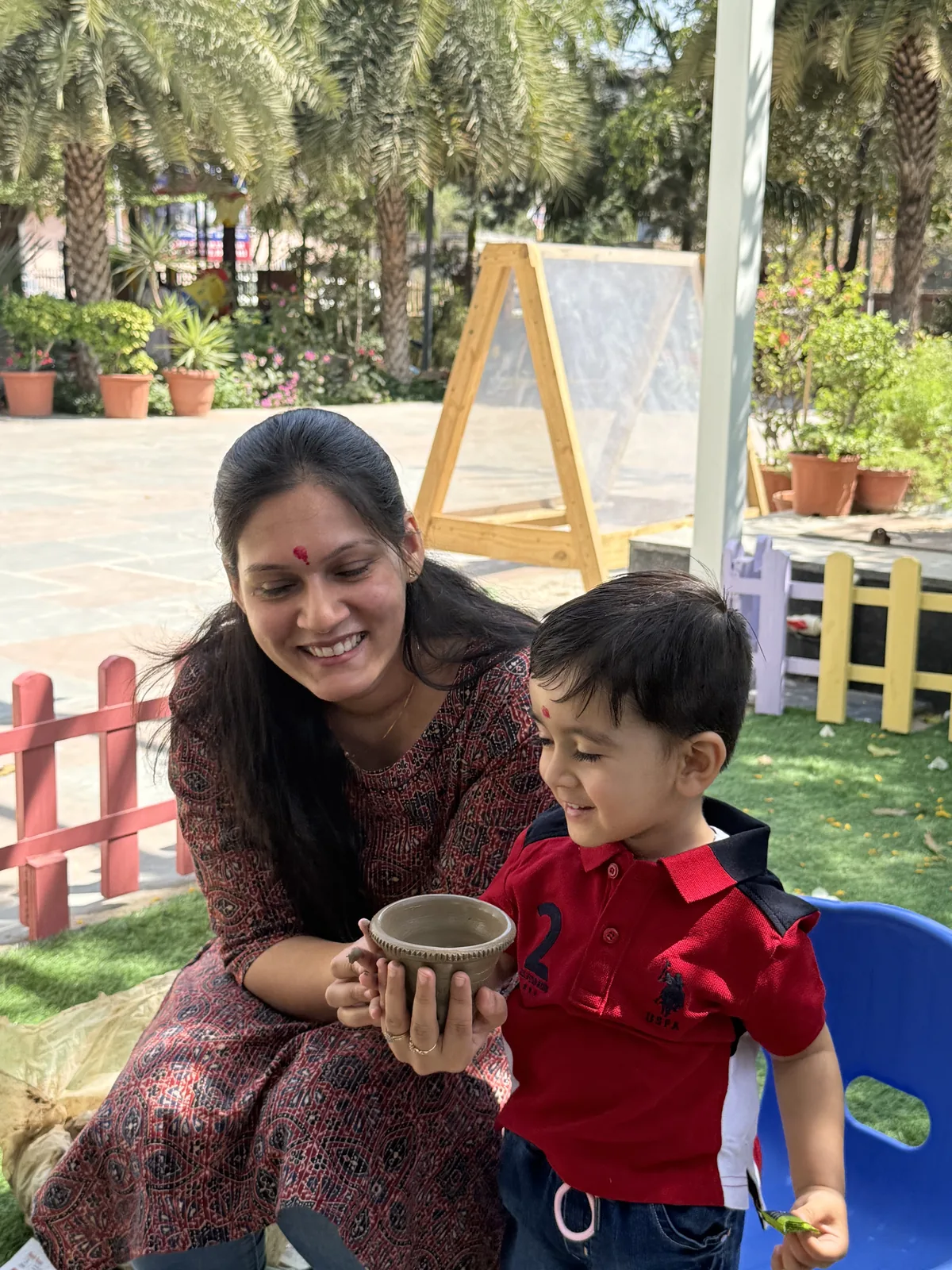 A toddler taking a confident first step in the school setting