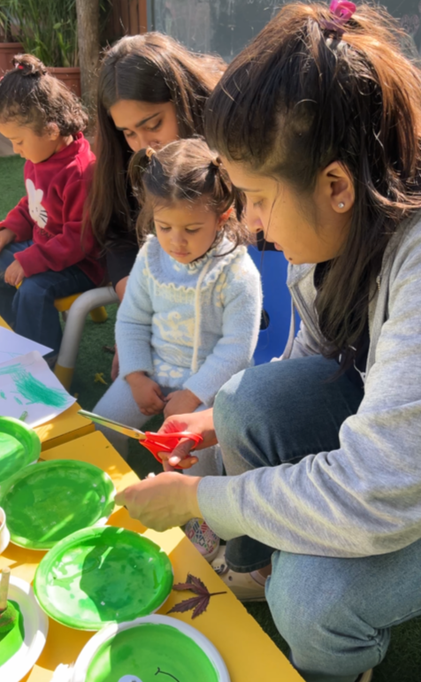 Mothers and toddlers doing a paper-plate craft activity together